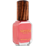 A bottle of Sienna Byron Bay Laughter nail lacquer with a pink shade and wooden cap, featuring gold text on the front of the glass container.