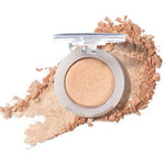 The 100% Pure Fruit Pigmented® Eye Shadow 2g by 100% Pure, a shimmery beige pressed powder, sits elegantly with a hint of scattered powder on a white background.