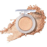 The 100% Pure Fruit Pigmented® Eye Shadow 2g by 100% Pure, a shimmery beige pressed powder, sits elegantly with a hint of scattered powder on a white background.