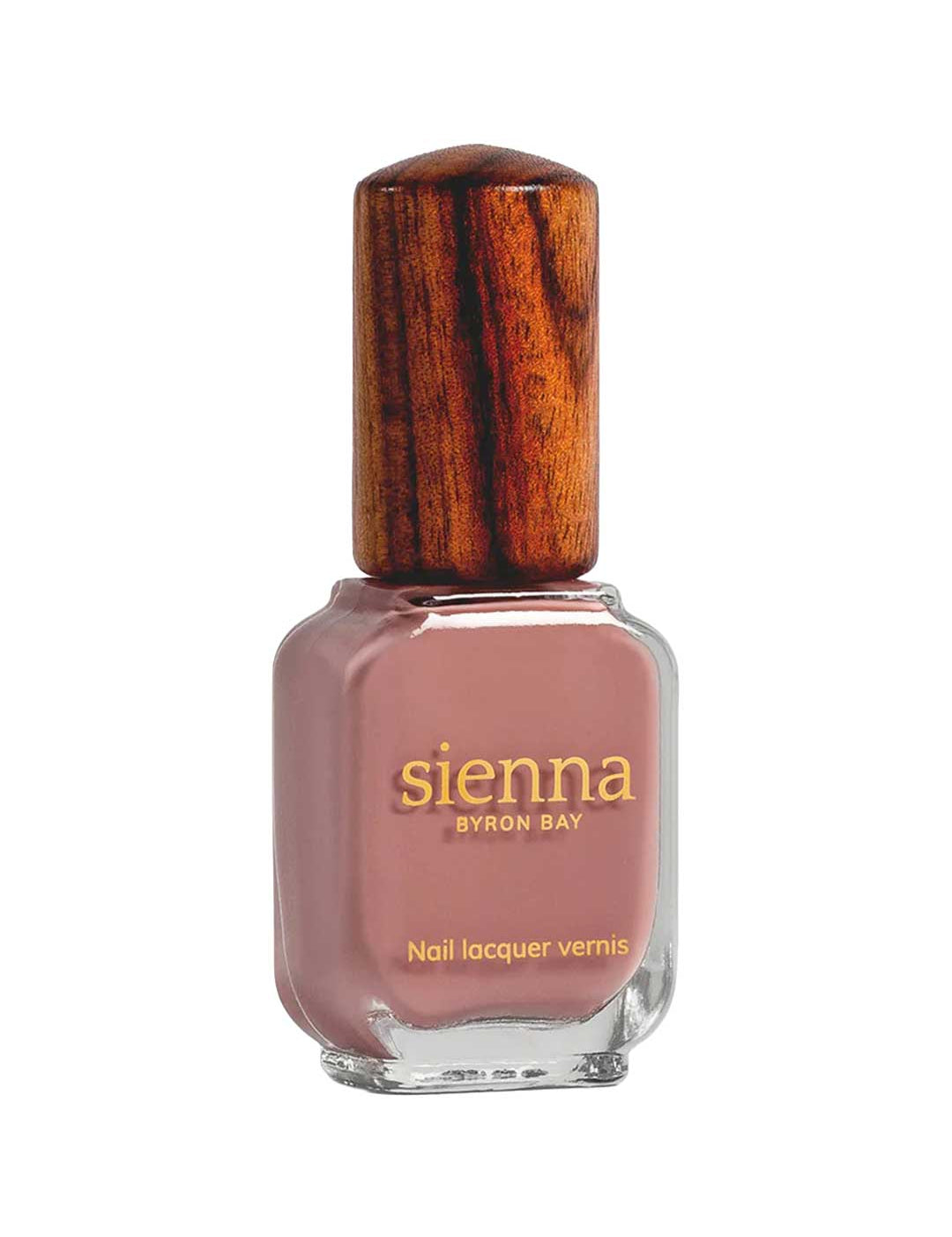 A bottle of Sienna Byron Bay Nail Polish in the shade Stone, featuring a brown wooden cap and a muted mauve-pink color, displayed against a white background.