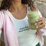 Woman holding an iced Nutra Naturals Collagen Strawberry Matcha Latte