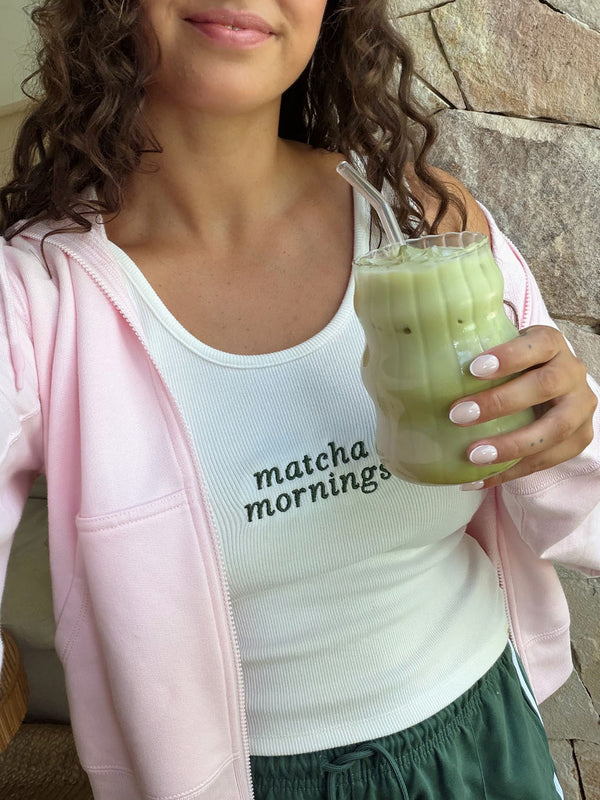 Woman holding an iced Nutra Naturals Collagen Strawberry Matcha Latte
