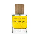 Perfume bottle labeled 'Suchness' with a wooden cap on a white background