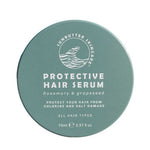 A round teal container of SunButter Skincare Protective Hair Serum 70ml for all hair types, with rosemary oil and grapeseed, shields hair from chlorine and salt damage.