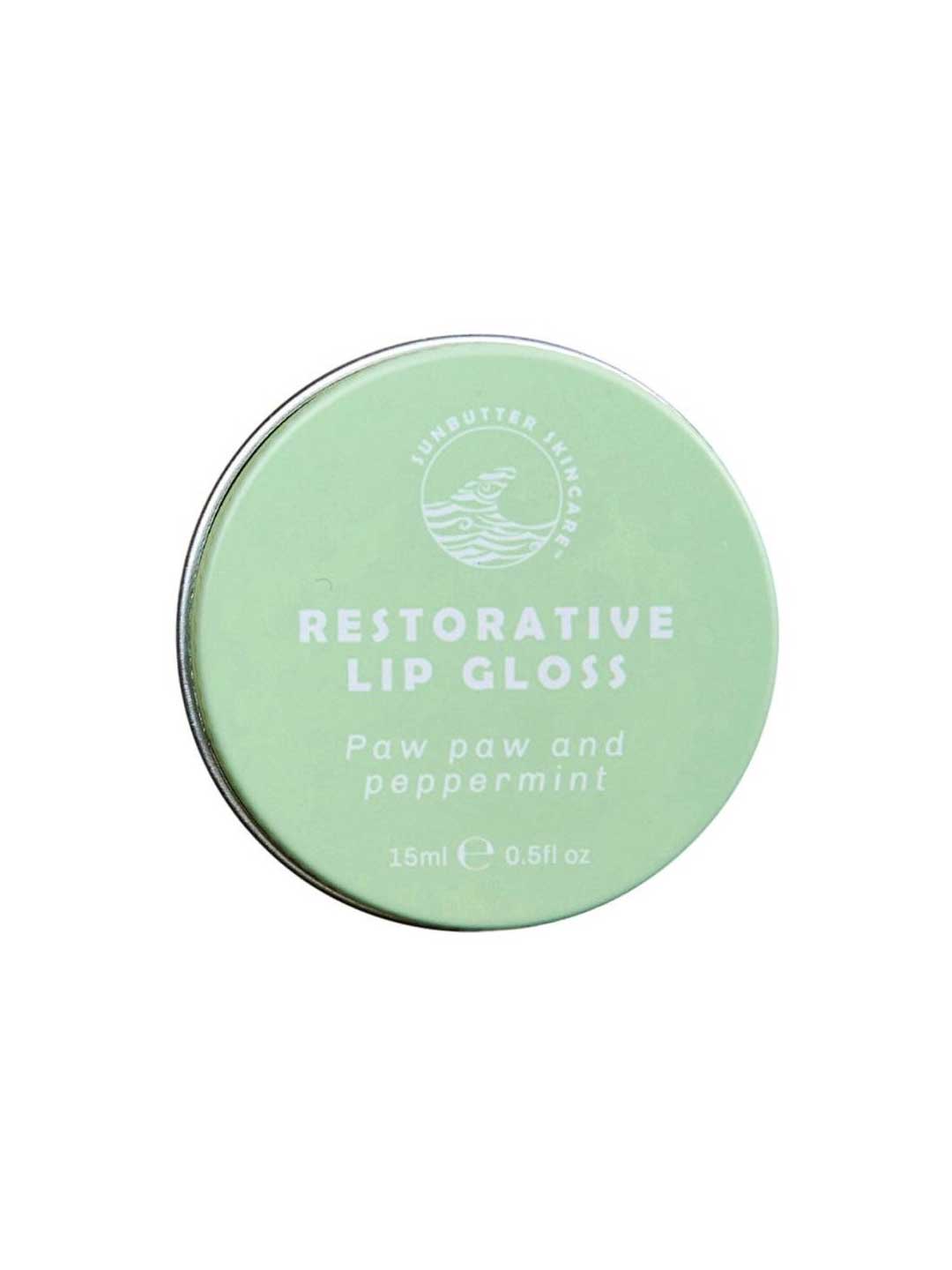 The SunButter Skincare Restorative Lip Gloss 15ml comes in a round, light green tin with the brand’s logo. This vegan lip balm blends paw paw and peppermint for soothing, hydrating lip care.