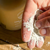 SunButter Deep Cleansing Powder in hand