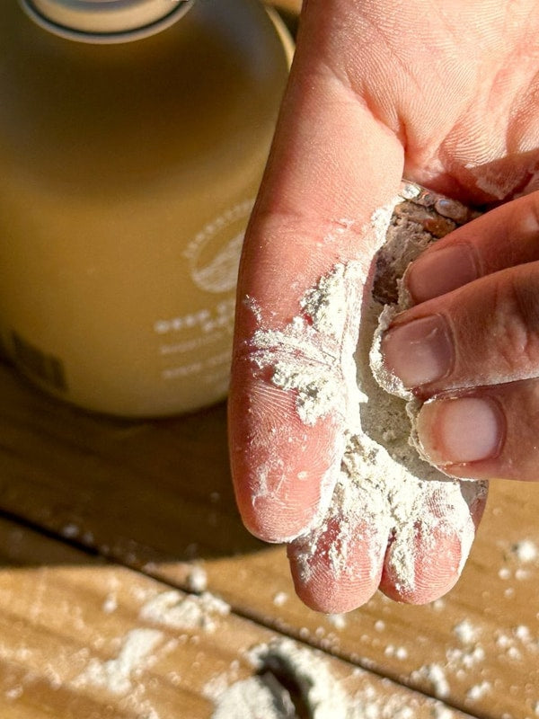 SunButter Deep Cleansing Powder in hand