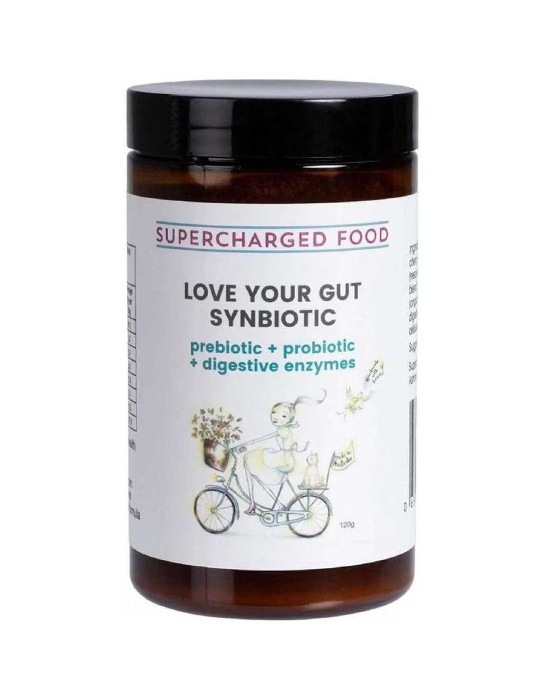 A brown jar labeled Supercharged Food Love Your Gut Synbiotic Powder 120g, featuring prebiotics, probiotics, and digestive enzymes. The label shows a person riding a bicycle with flowers.