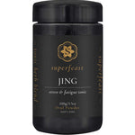 A black container of Superfeast Jing Powder 100g features gold and white text, a gold emblem, and is labeled as an energy tonic for adrenal support; it contains a tonic herb blend in oral powder form.