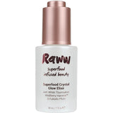 A 30ml bottle of Raww Superfood Crystal Glow Serum with a rose gold cap features white tourmaline, wildberry harvest, and kakadu plum for radiant skin.