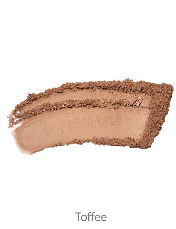 A curved smear of light brown 100% Pure Rice Powder Foundation 9g in the shade Toffee is shown on a white background.
