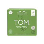 A green box of TOM Organic Pads Extra Regular 10pk with organic cotton, minimal line art of a woman, eco-friendly icons, and product details. These non-toxic pads provide plant-based softness and gentle care for your skin.