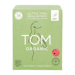 A green box of TOM Organic Pads Regular 10pk, made with organic cotton, features a minimalist woman line drawing, highlights hypoallergenic and biodegradable pads, and displays a pink certified organic label.