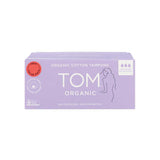 A lavender box of TOM Organic Tampons Super 32pk with white text, the TOM Organic logo, an outline of a woman, and icons for 32 super tampons. The biodegradable tampons contain no pesticides or synthetics.