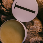 Open tin of Tuttofare Holy Grail Tallow Balm on terracotta