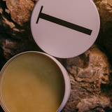 Open tin of Tuttofare Holy Grail Tallow Balm on terracotta