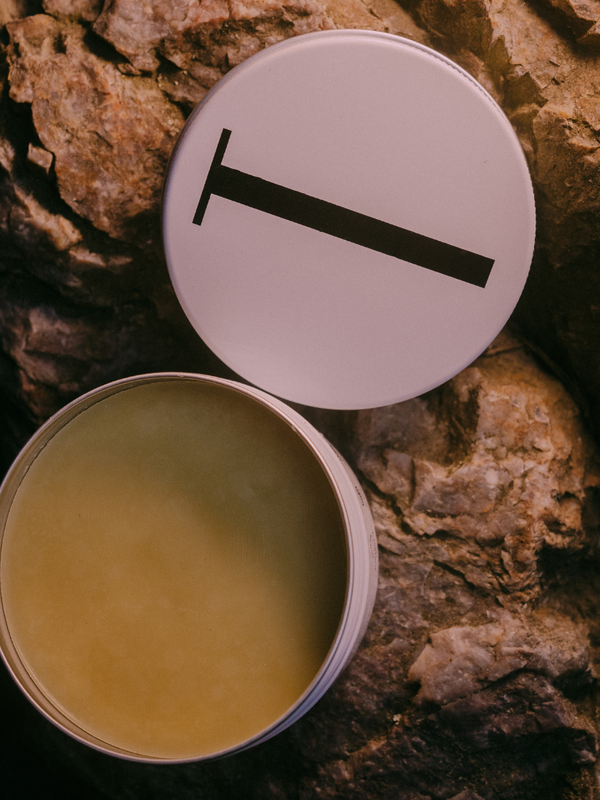 Open tin of Tuttofare Holy Grail Tallow Balm on terracotta