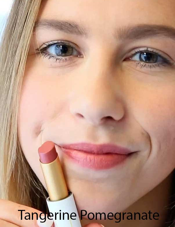 A smiling person holds a tube of Luk Beautifood Lip Nourish Lipsticks 3g in a pink shade near their lips. "Tangerine Pomegranate" appears at the bottom of the image.
