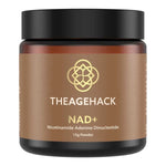 Small amber The Age Hack NAD+ powder jar with a broad black screw lid and a gold-brown label, with a gold geometric emblem above white brand lettering and the NAD+ name.