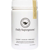 A white container of The Beauty Chef Daily Supergreens Inner Beauty Support Pineapple 150g features text on cleansing, alkalizing, and rebalancing. This pineapple-flavored supergreens powder contains probiotics for gut health support.