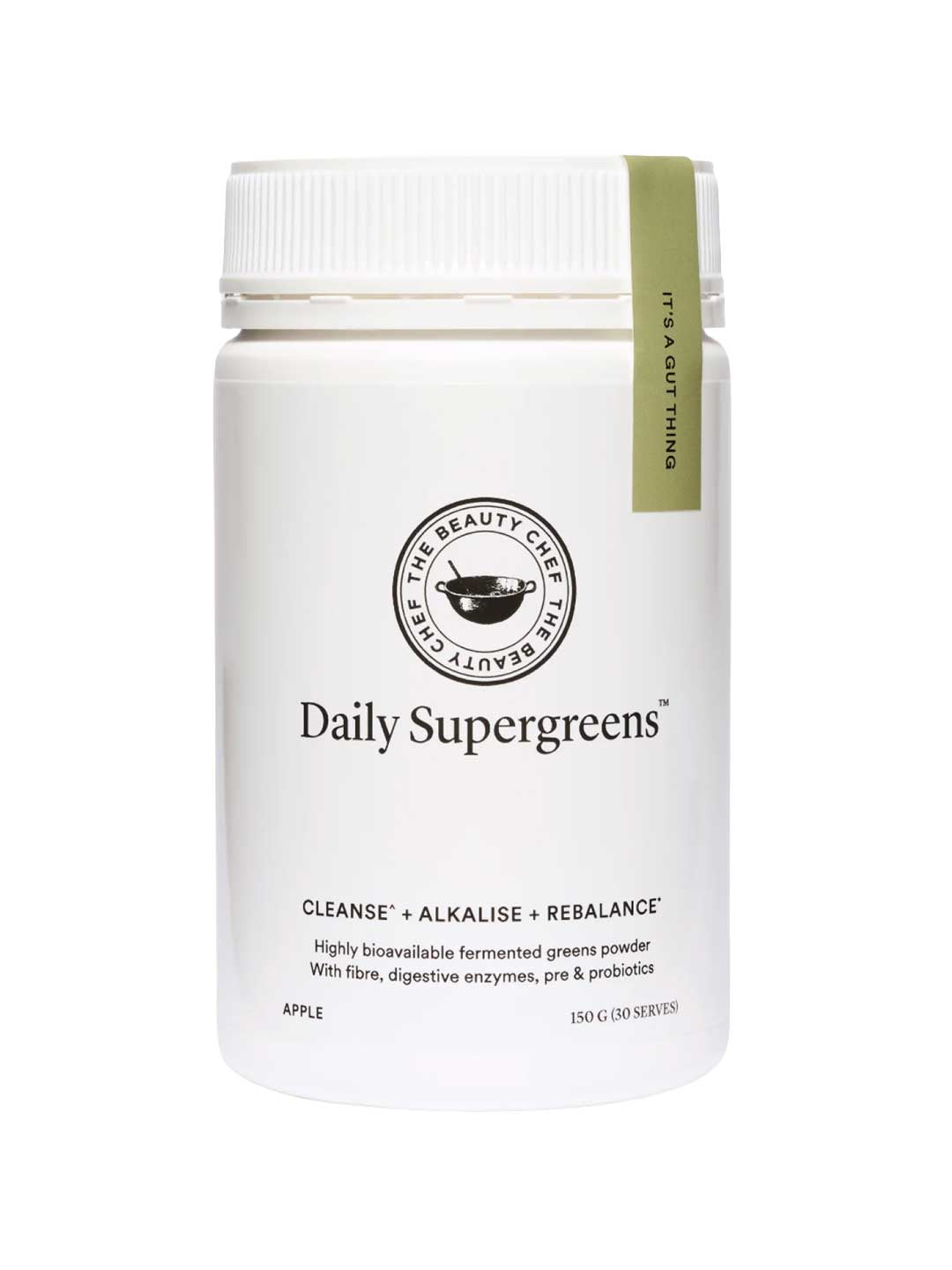 A white container labeled The Beauty Chef Daily Supergreens Inner Beauty Support Apple 150g, with a green tag. This powder supports cleansing, alkalizing, and rebalancing with apple flavor, fiber, digestive enzymes, and probiotics for gut health.