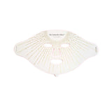 The Vanessa Megan The Butterfly Effect Medical-Grade Silicone LED Face Mask is a white mask with eye, nose, and mouth cutouts, adorned with gold lines and dots—an elegant at-home skincare device.