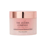 A pink and rose gold 50ml jar of The Jojoba Company Jojoba & Enzyme Radiance Mask, featuring the product name and “7 Phyto AHAs & BHAs” printed on the front.