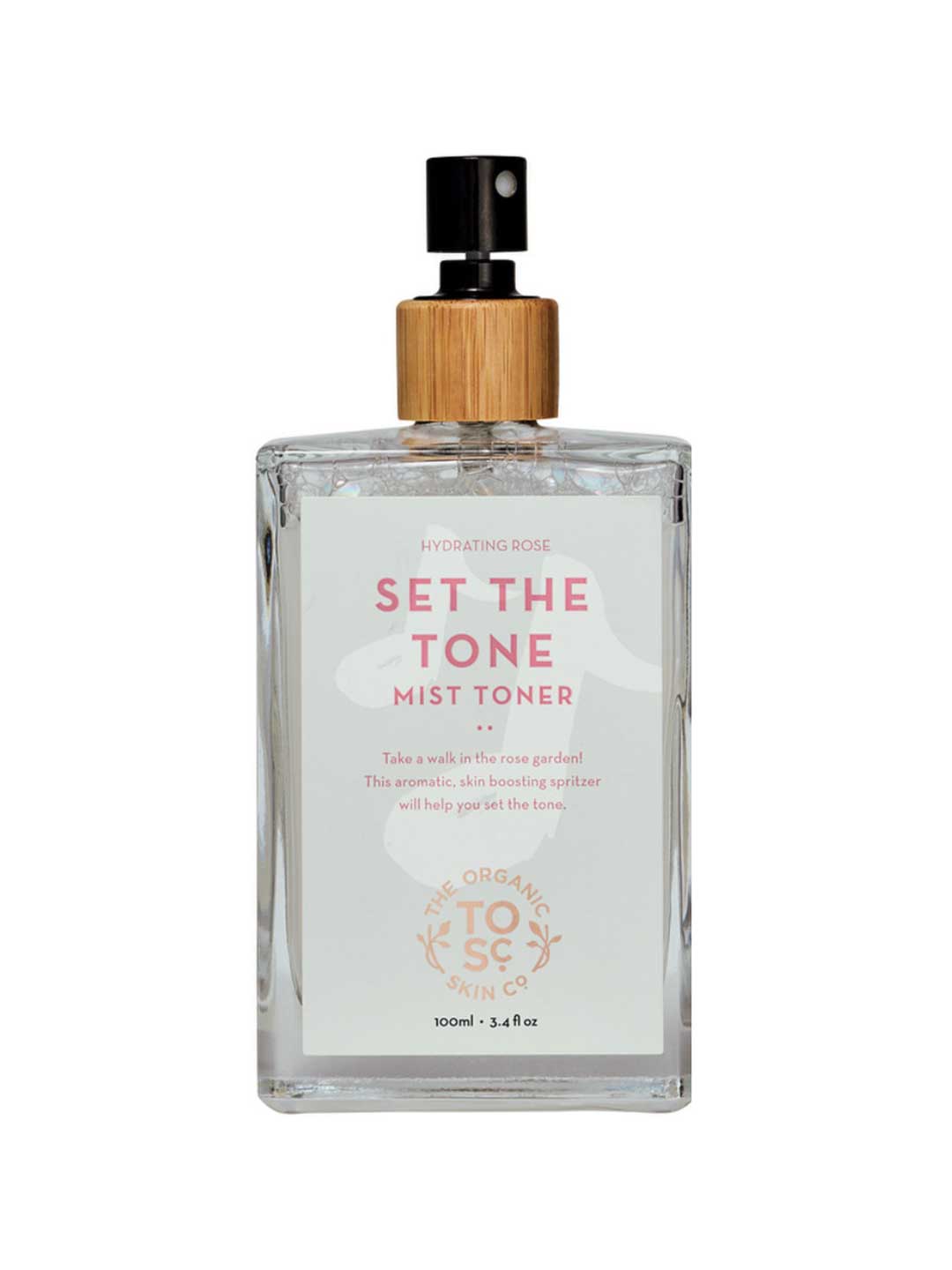 A clear spray bottle of The Organic Skin Co Set The Tone Mist Toner 100ml, topped with a wooden cap, contains hydrating rose water—an organic facial mist ideal for refreshing and balancing your skin.