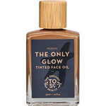 A 30ml bottle of The Organic Skin Co The Only Glow Tinted Face Oil Medium, featuring a wooden cap and dark label with white and gold text, offers organic makeup for a luminous complexion.