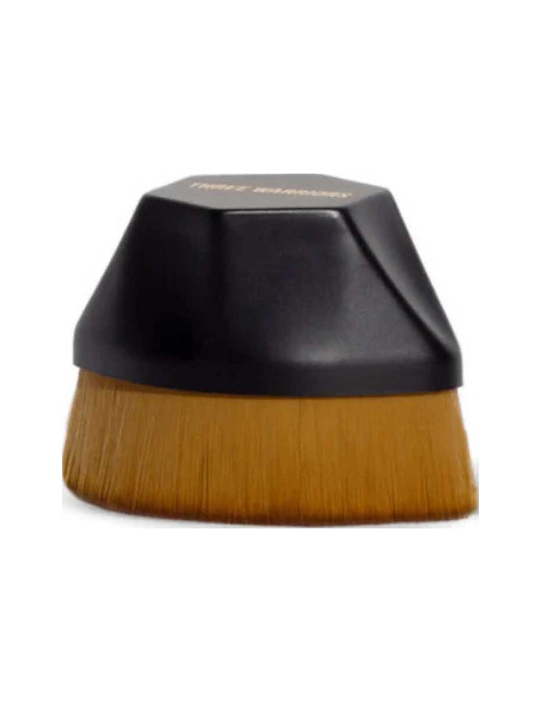 Three Warriors Beauty Buff Brush with a short, faceted black grip above a broad, dense row of golden-brown bristles.