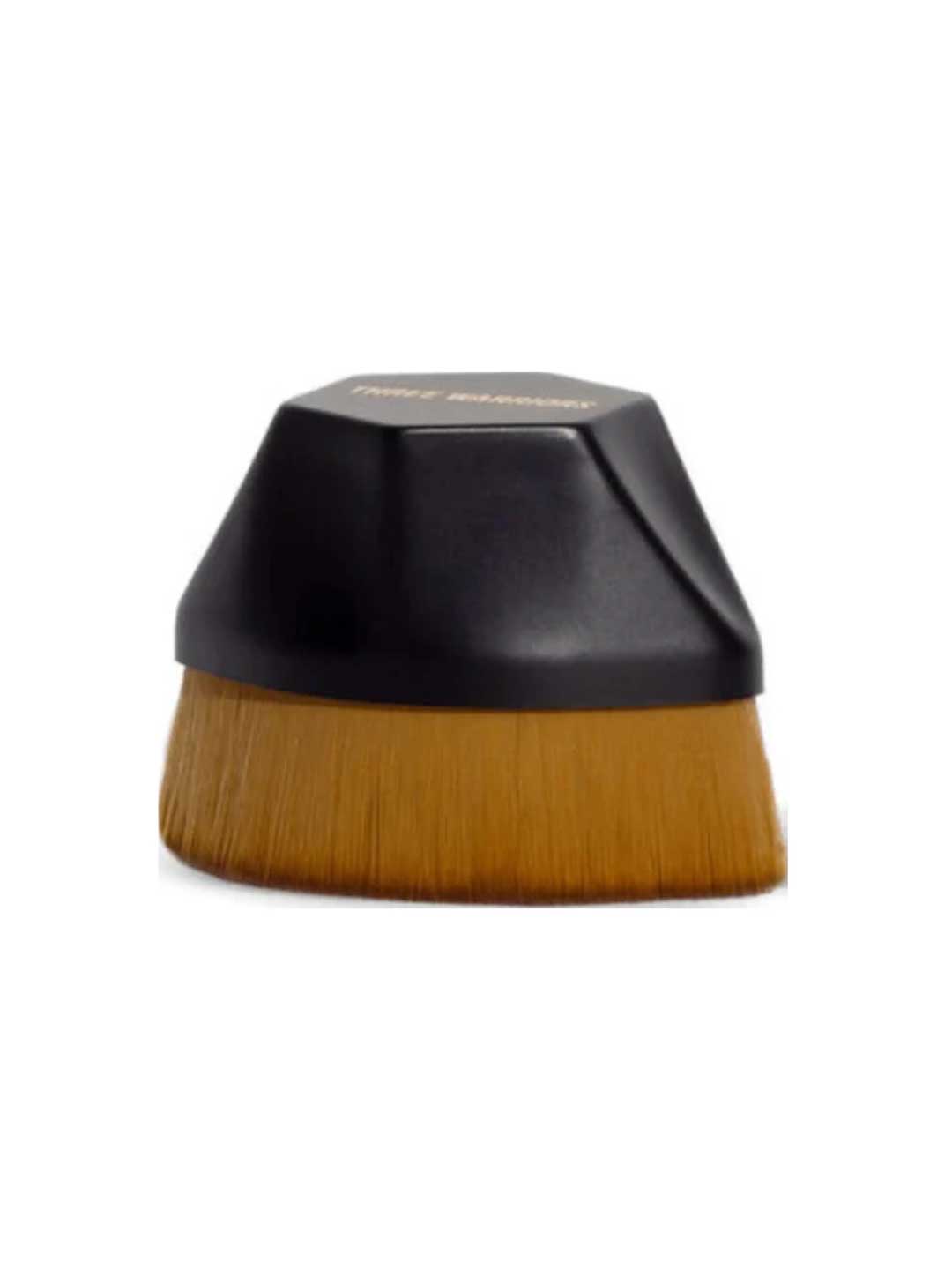 The Three Warriors Beauty Buff Brush features dense brown bristles and a short, rounded black handle for streak-free self-tan application. Shown against a white background, it’s perfect as a self-tan applicator.