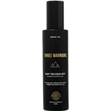 A 150ml black bottle of Three Warriors Body Tan Aqua Mist, an organic tanning water with gold and white text and a three mountain peaks logo. Made in Australia.