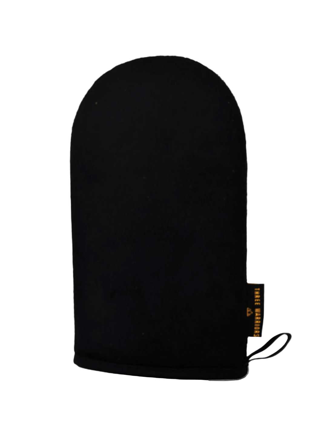The Three Warriors Eco Friendly Tanning Mitt is a black mitt with a rounded top, hanging loop, and black-and-gold side tag, designed for streak-free self-tanning mousse application. Shown on a plain white background.