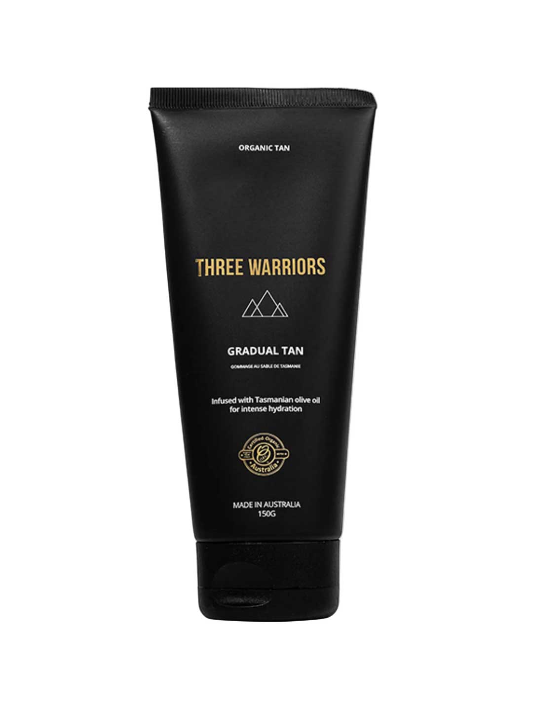 A black tube labeled "Three Warriors Gradual Tan 150g," a certified organic self-tanner made in Australia with natural DHA and Tasmanian olive oil for hydration, featuring gold and white text and symbols.