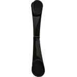 A black, curved hair clip with rounded ends and a central hinge is shown on a white background, ideal for holding hair in place while using the Three Warriors Self-Tan Back Applicator.