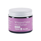 A 70ml jar of Thrive Tallow Whipped Tallow Moisturiser Ylang Ylang & Vanilla, with a purple label highlighting whipped balm benefits in white text and a white screw lid.
