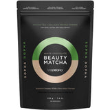 A black resealable pouch labeled Nutra Organics Tropeaka White Chocolate Beauty Matcha 210g, a matcha tea and collagen peptide powder for teas, lattes, and cold drinks with a highlighted white chocolate flavor.