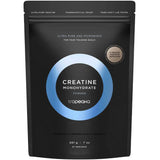 A black resealable pouch labeled Tropeaka Creatine Monohydrate 200g features a blue and white circular design, emphasizing its lab-tested, pharmaceutical-grade purity to support muscle strength.