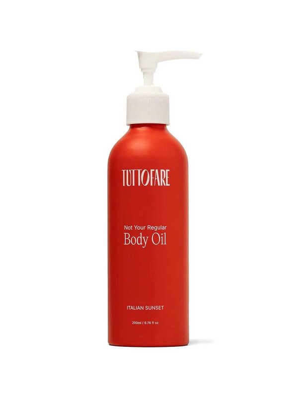A red bottle of Tuttofare Not Your Regular Body Oil 200ml with a white pump dispenser; the label reads "Italian Sunset" and describes it as a nourishing natural moisturizer, containing 6.7 fl oz.