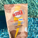 She BANG! Milk Chocolate Peri Protein POWder pouch beside a swimming pool