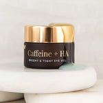 Vanessa Megan Caffeine and HA Bright and Tight Eye Gel jar on stones