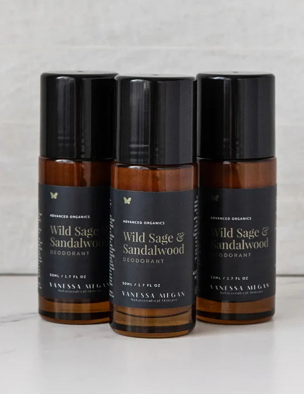 Three amber Vanessa Megan Wild Sage & Sandalwood roll-on deodorant bottles grouped together, each with a black cap and black label.