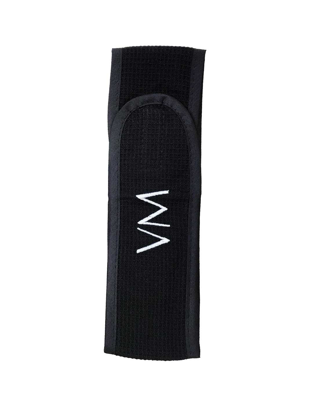 The Vanessa Megan 100% Cotton Waffle Beauty Headband in black features a centered white zigzag embroidery and is perfect for your daily skincare routine. Photographed on a plain white background.