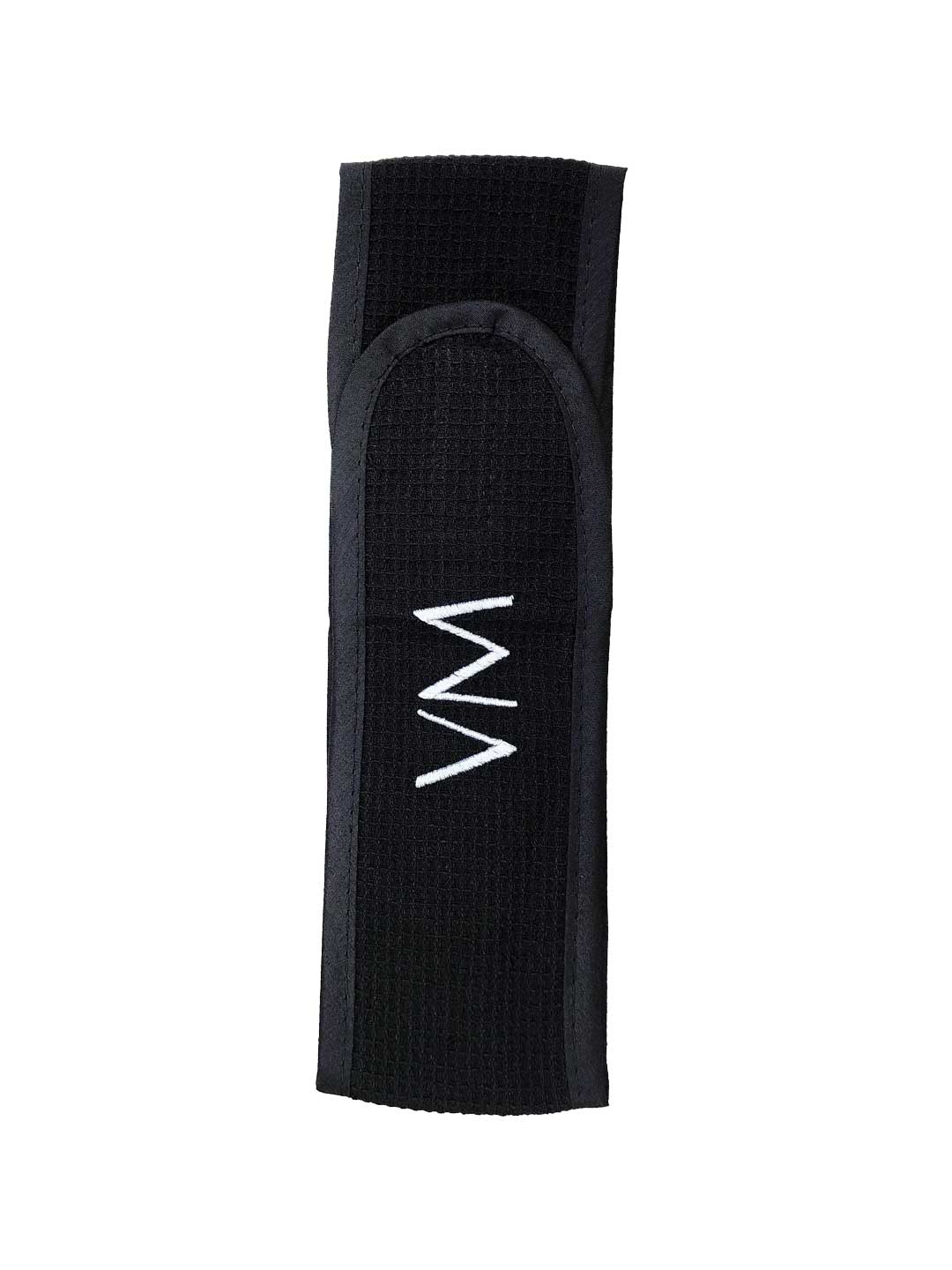The Vanessa Megan 100% Cotton Waffle Beauty Headband in black features a centered white zigzag embroidery and is perfect for your daily skincare routine. Photographed on a plain white background.