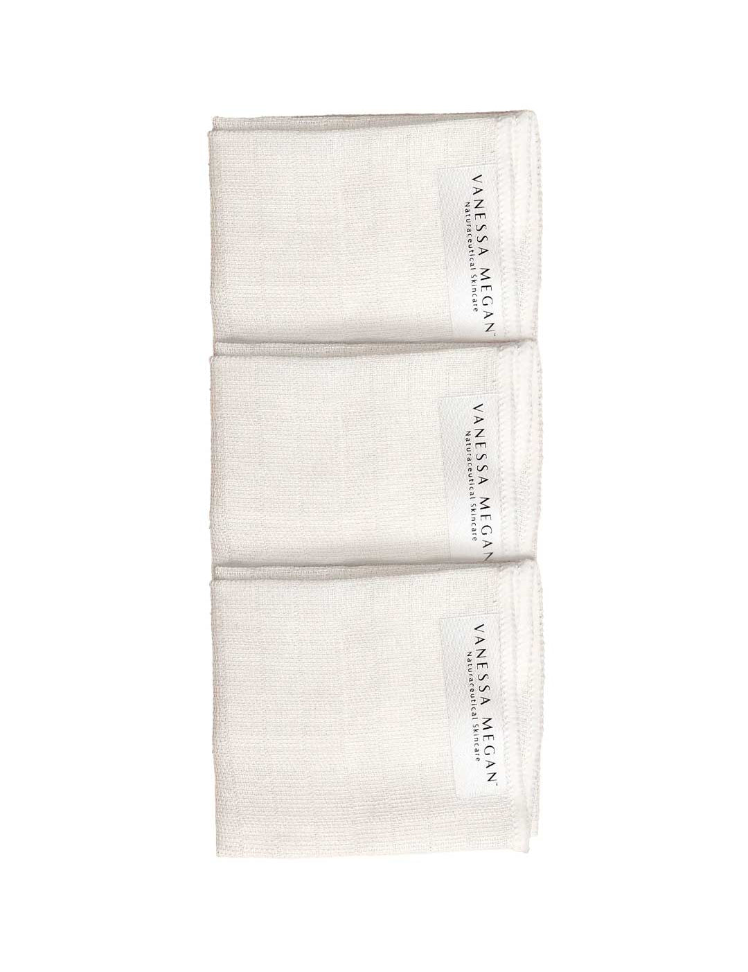A vertical row of Vanessa Megan 100% Organic Muslin Face Cloths (3-pack) is neatly folded to show branded labels, set against a plain white background.