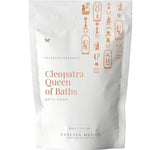 A white pouch labeled Vanessa Megan Cleopatra Queen of Baths Bath Soak/Scrub with gold Egyptian-style symbols. This 500g vegan milk bath soak, from their advanced organics line, is designed for radiant skin.