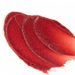 A close-up of three overlapping swipes of Vanessa Megan Glowing Lip & Cheek Tinted Balm 10g in glossy red on a white background, showcasing its smooth, creamy texture.