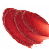 A close-up of three overlapping swipes of Vanessa Megan Glowing Lip & Cheek Tinted Balm 10g in glossy red on a white background, showcasing its smooth, creamy texture.