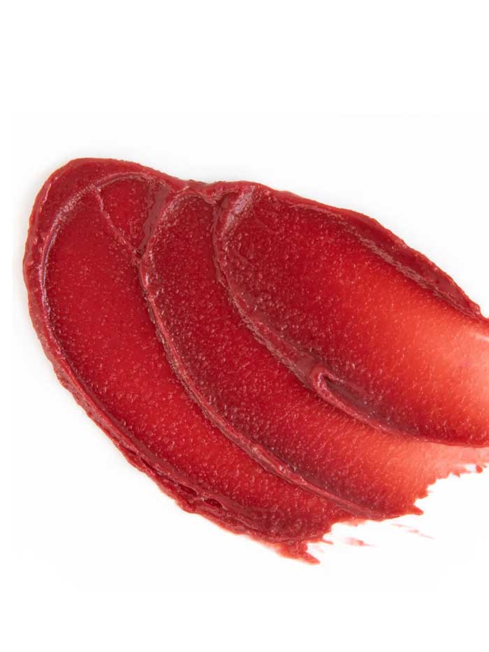 A close-up of three overlapping swipes of Vanessa Megan Glowing Lip & Cheek Tinted Balm 10g in glossy red on a white background, showcasing its smooth, creamy texture.