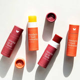 Four cylindrical tubes of tinted balm in orange and red shades, all labeled “Vanessa Megan Glowing Lip & Cheek Tinted Balm 10g,” are arranged on a white surface.